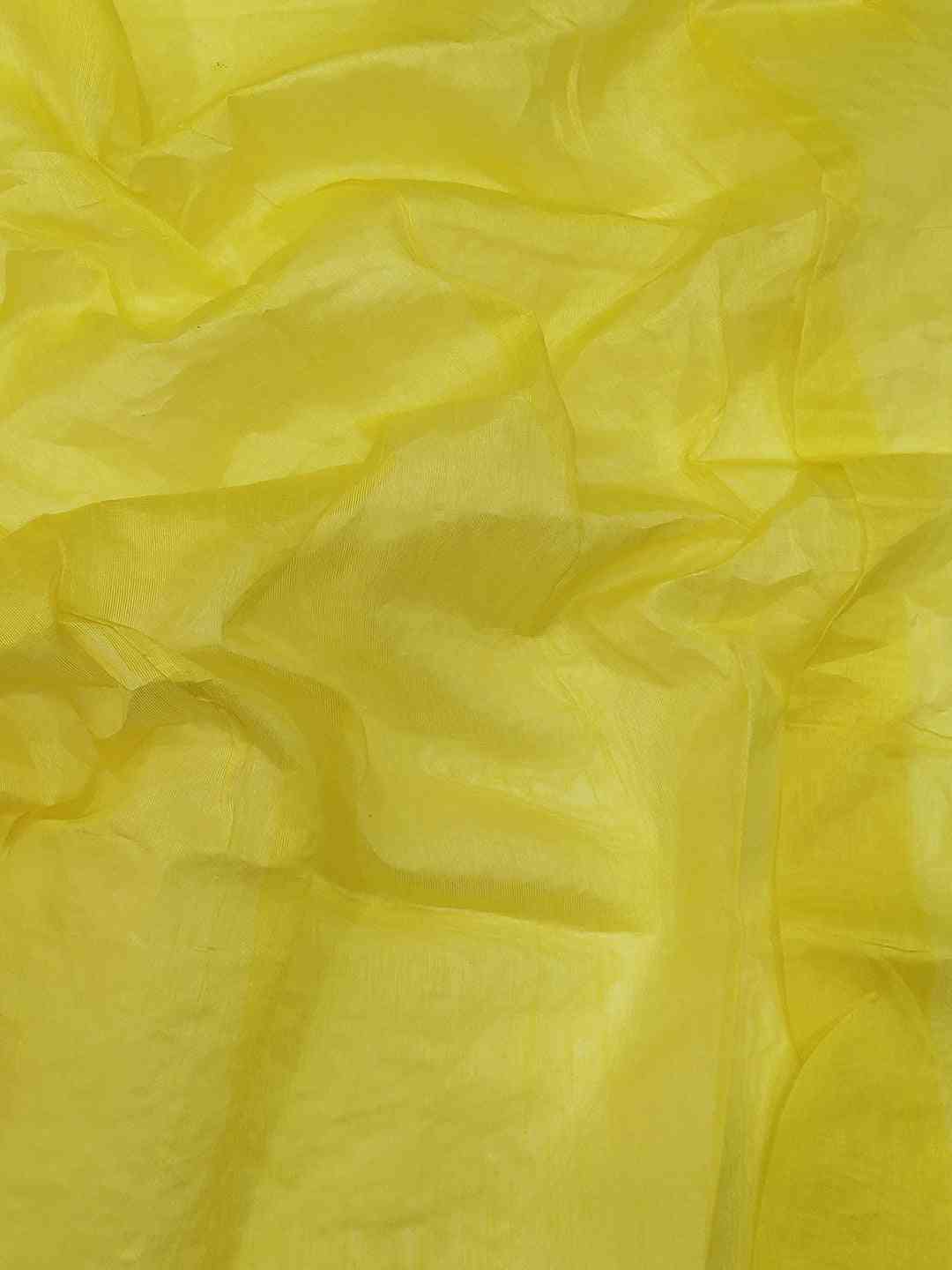 Close-up of yellow net fabric with subtle texture