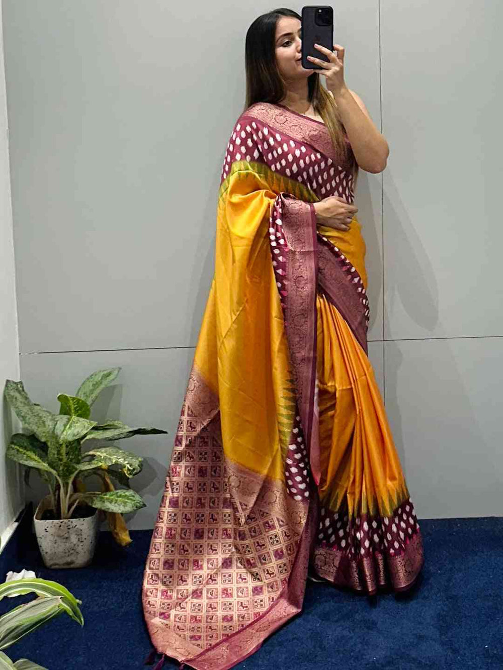 Woman taking mirror selfie in Banarasi Soft Silk Saree with Patola Pallu