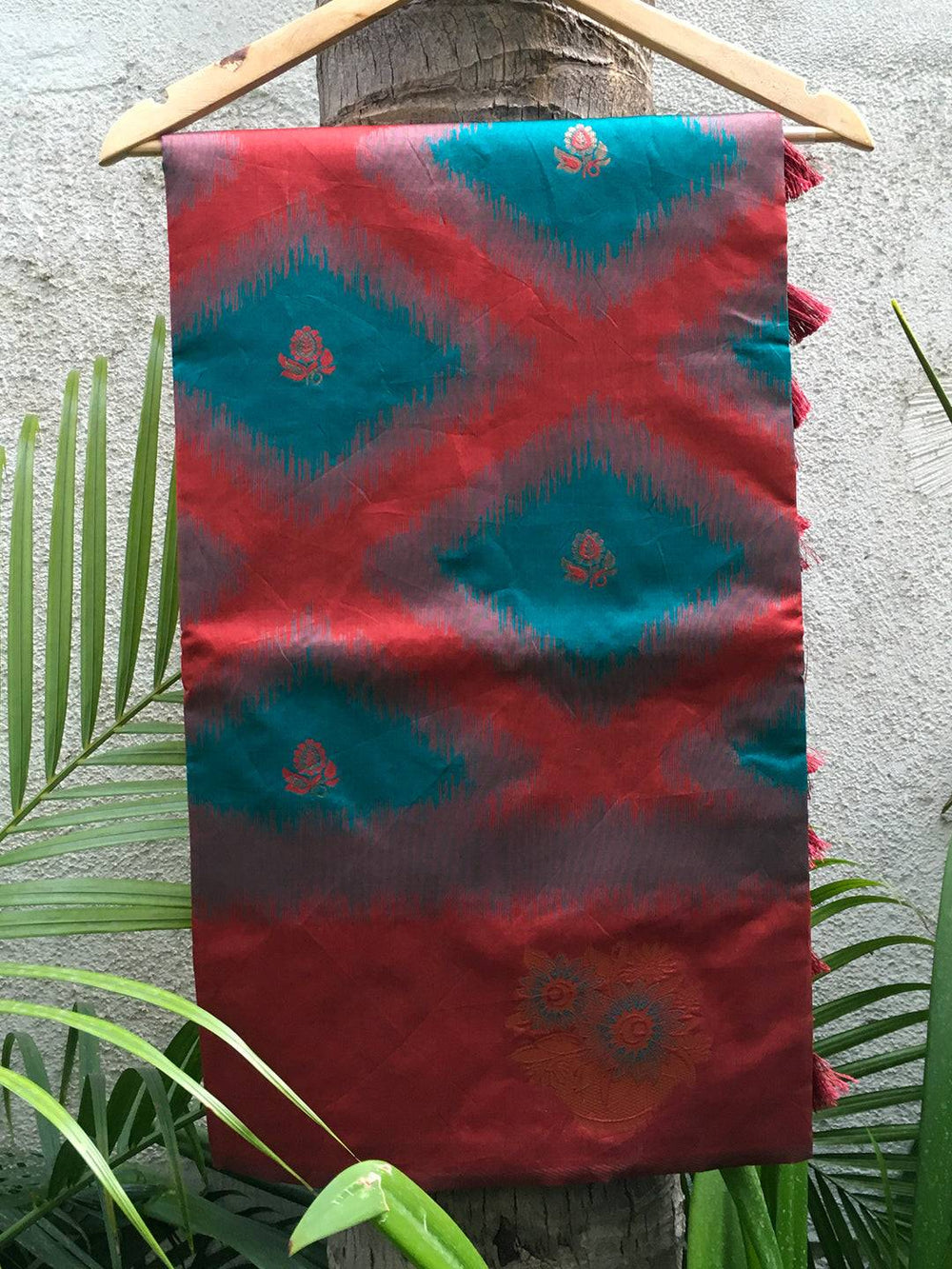 Teal and red Ikkat Weaving Saree displayed on hanger