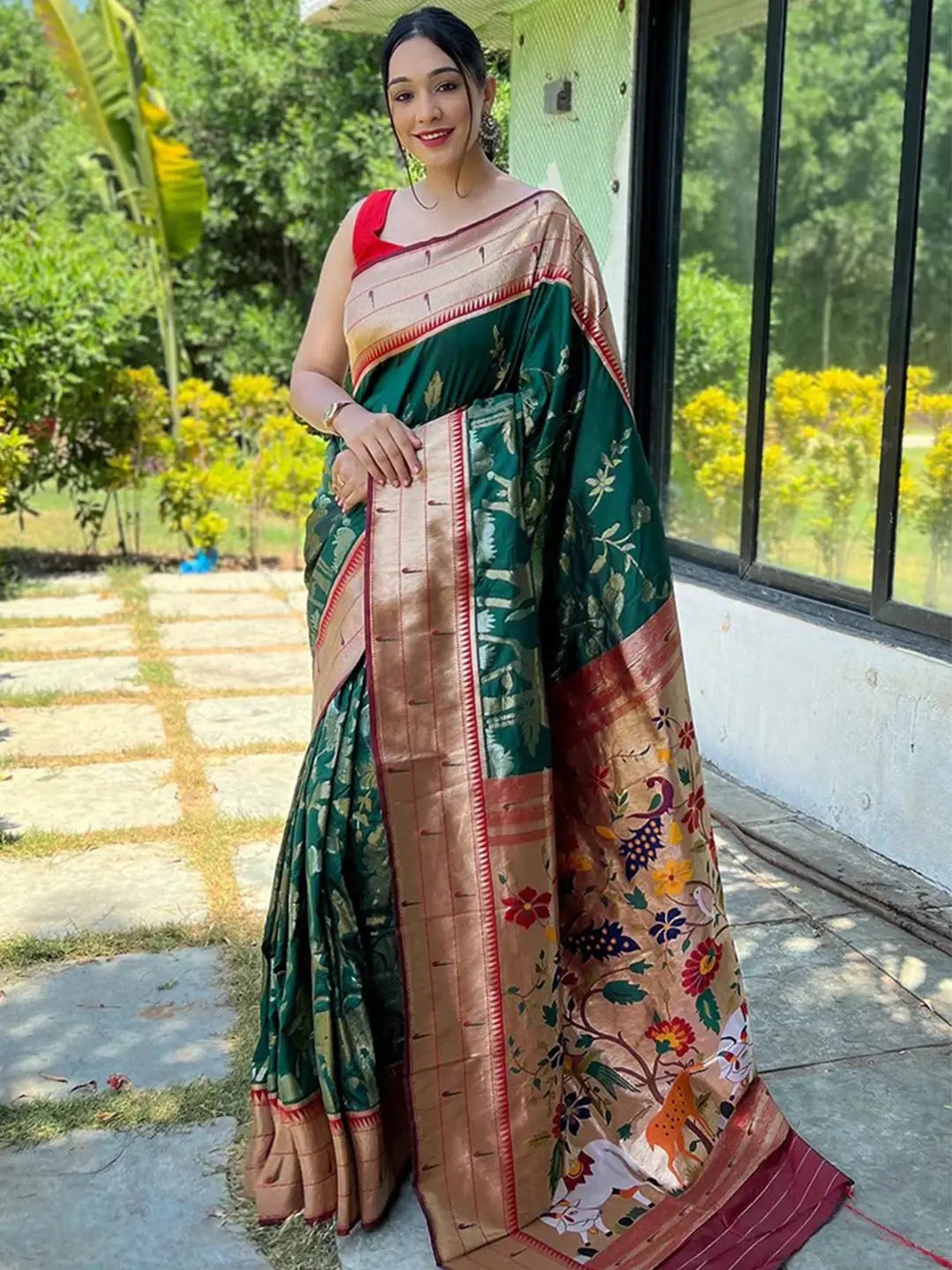 Model showcasing dark green Paithani silk saree with intricate pichwai design