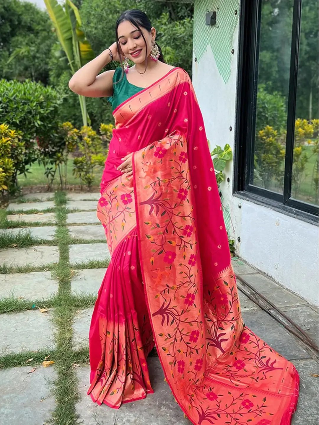 Woman wearing pink Paithani saree with big border outdoors