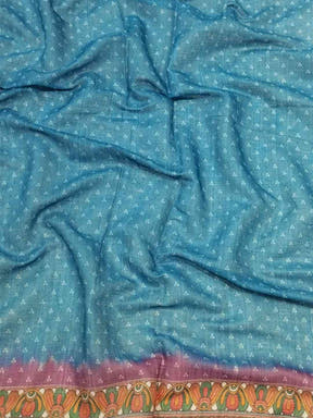 Close-up of blue linen saree fabric with Bandhej pattern