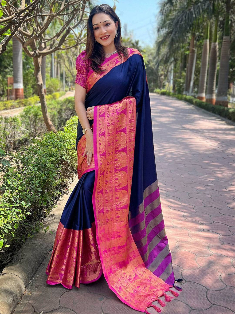 Elegant navy Kanjivaram saree with intricate pink border design