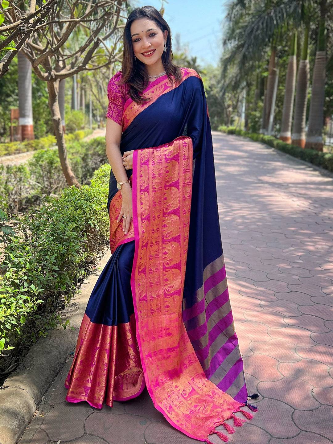 Elegant navy Kanjivaram saree with intricate pink border design