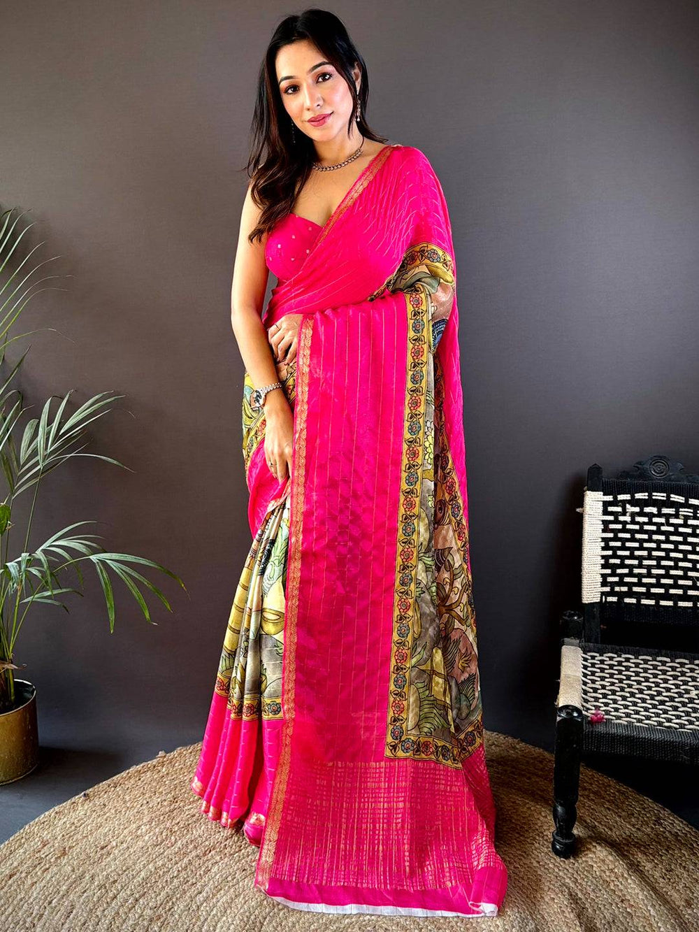 Vibrant pink Kalamkari saree with intricate border design