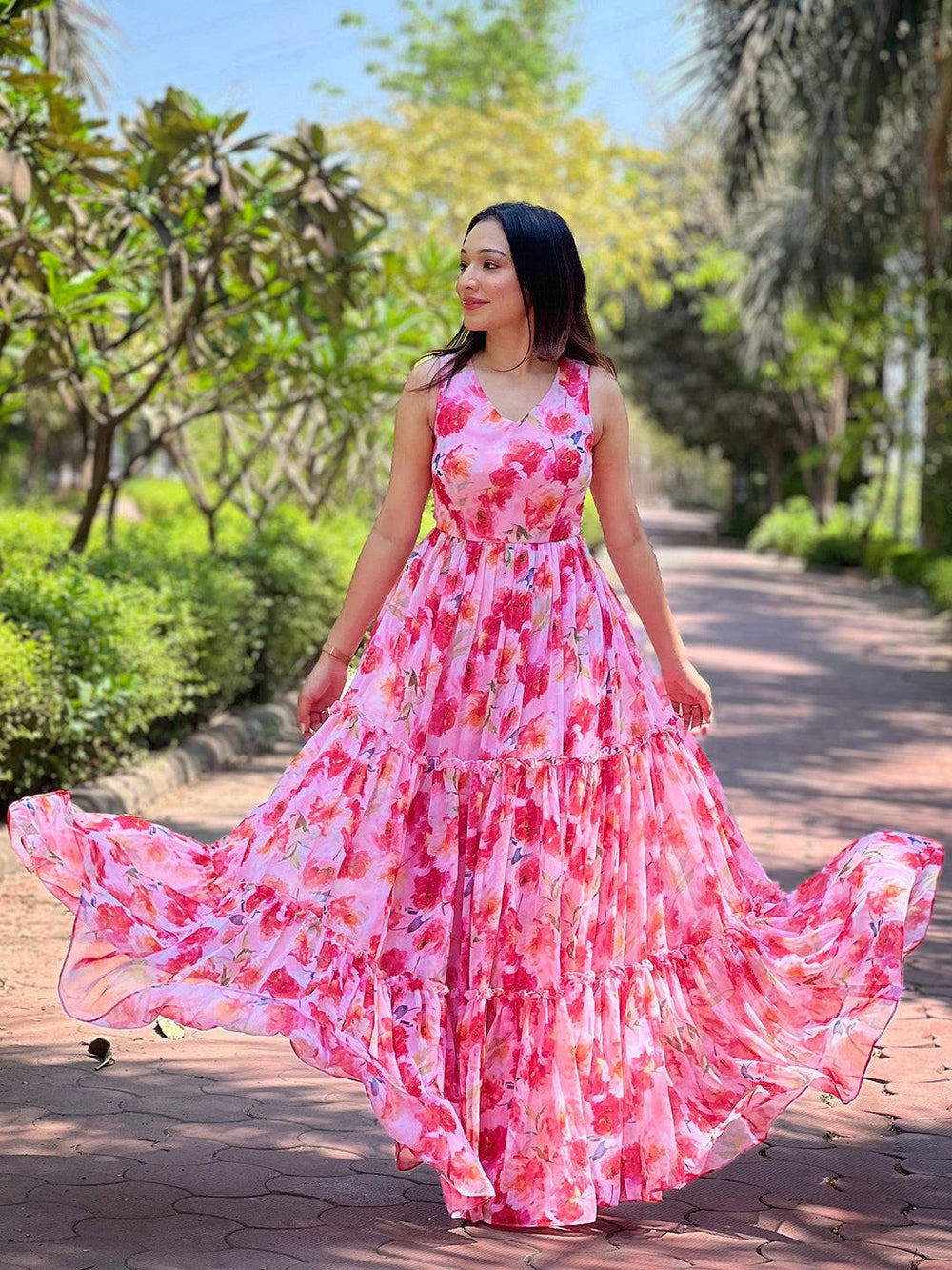 Neon pink floral print dress in garden setting