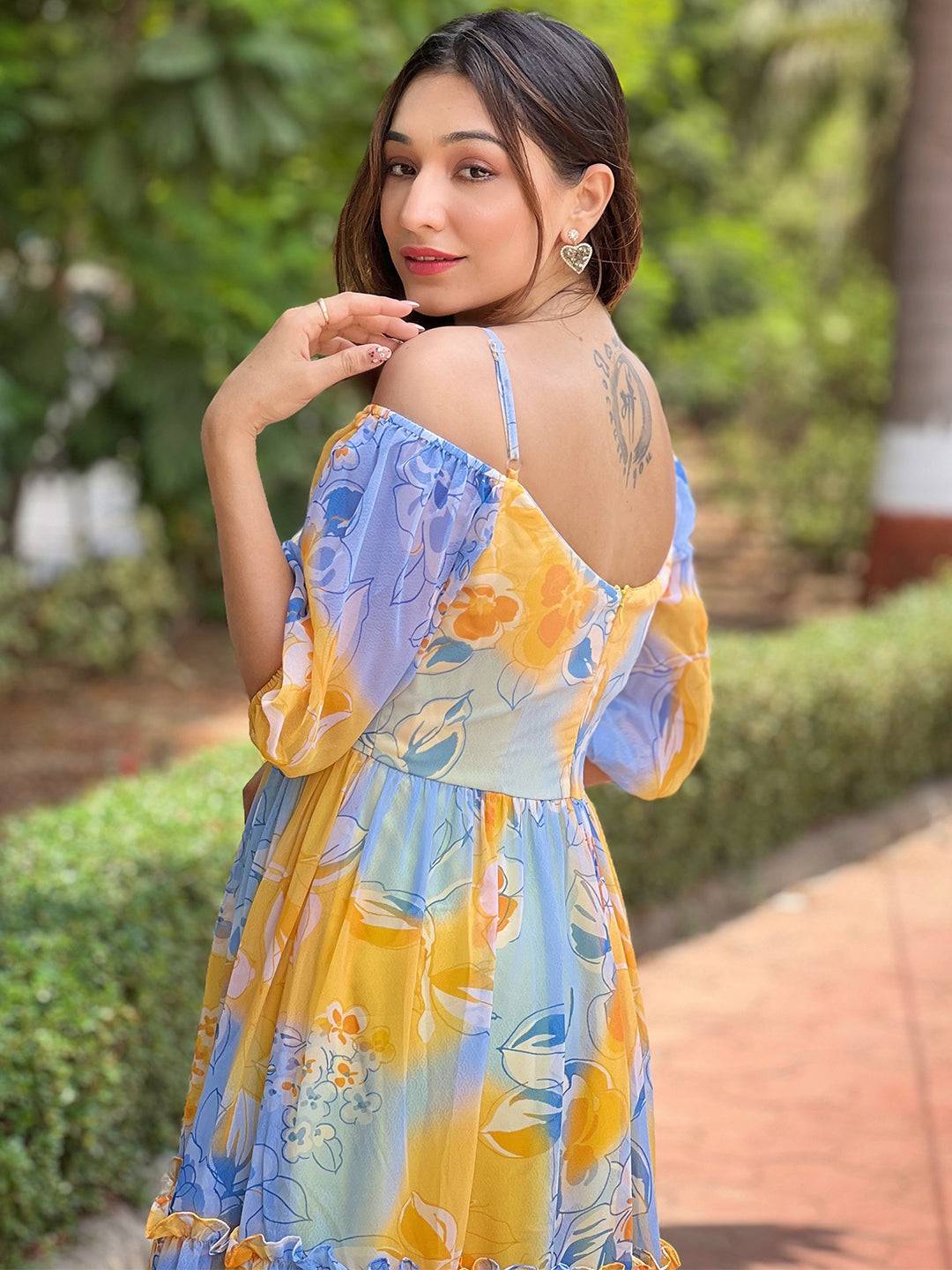 Back view of Masha Yellow Floral Dress outdoors