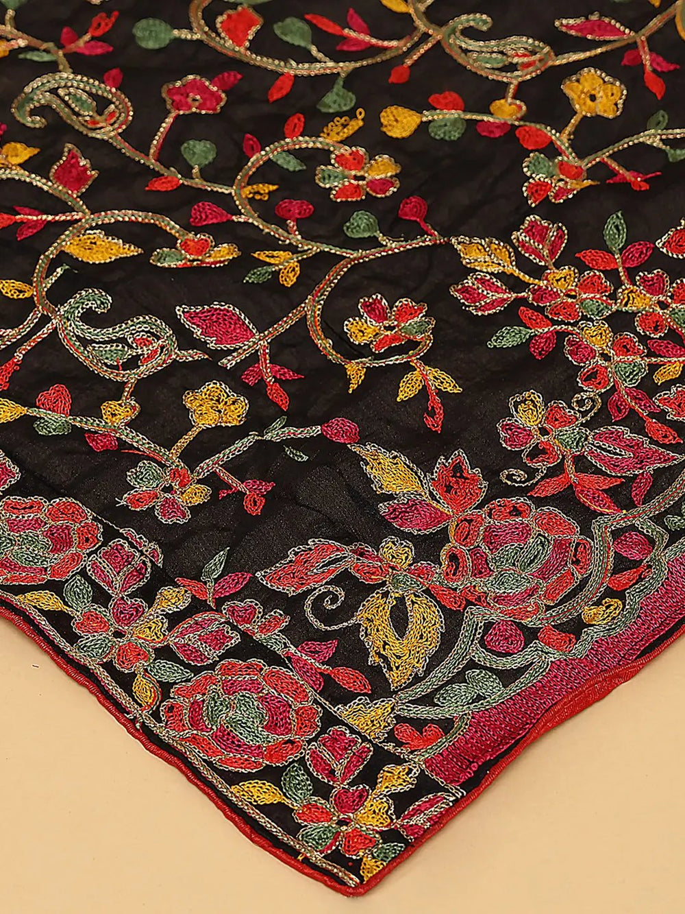 Close-up of black dupatta's colorful resham thread embroidery.