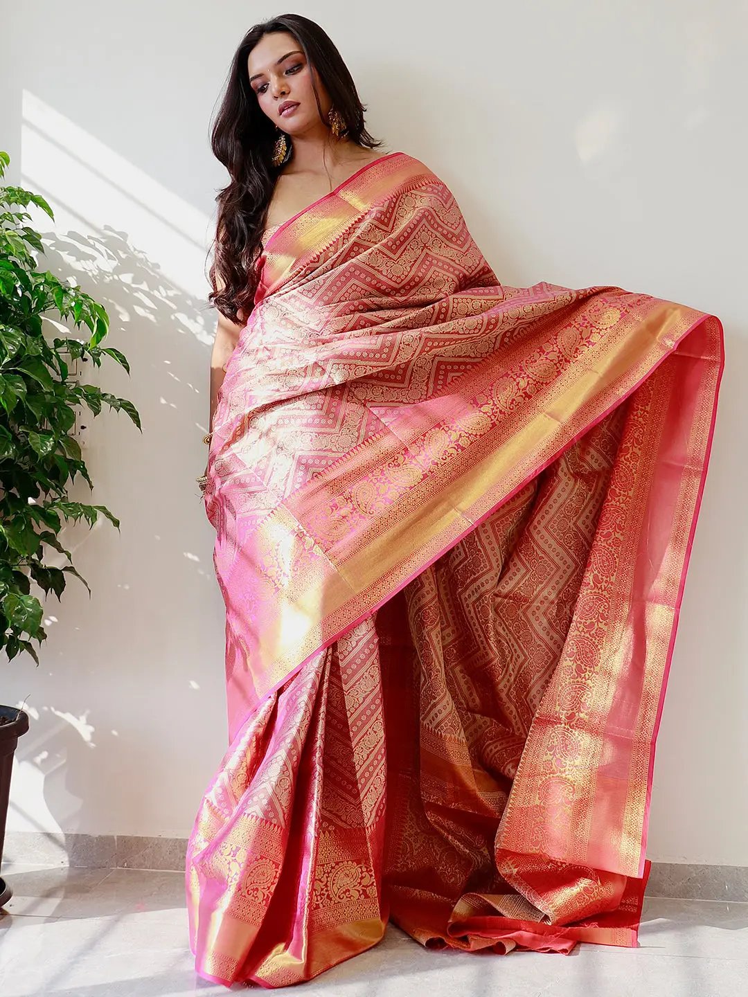 Elegant gold zari Kanjivaaram pattu silk saree draped gracefully.