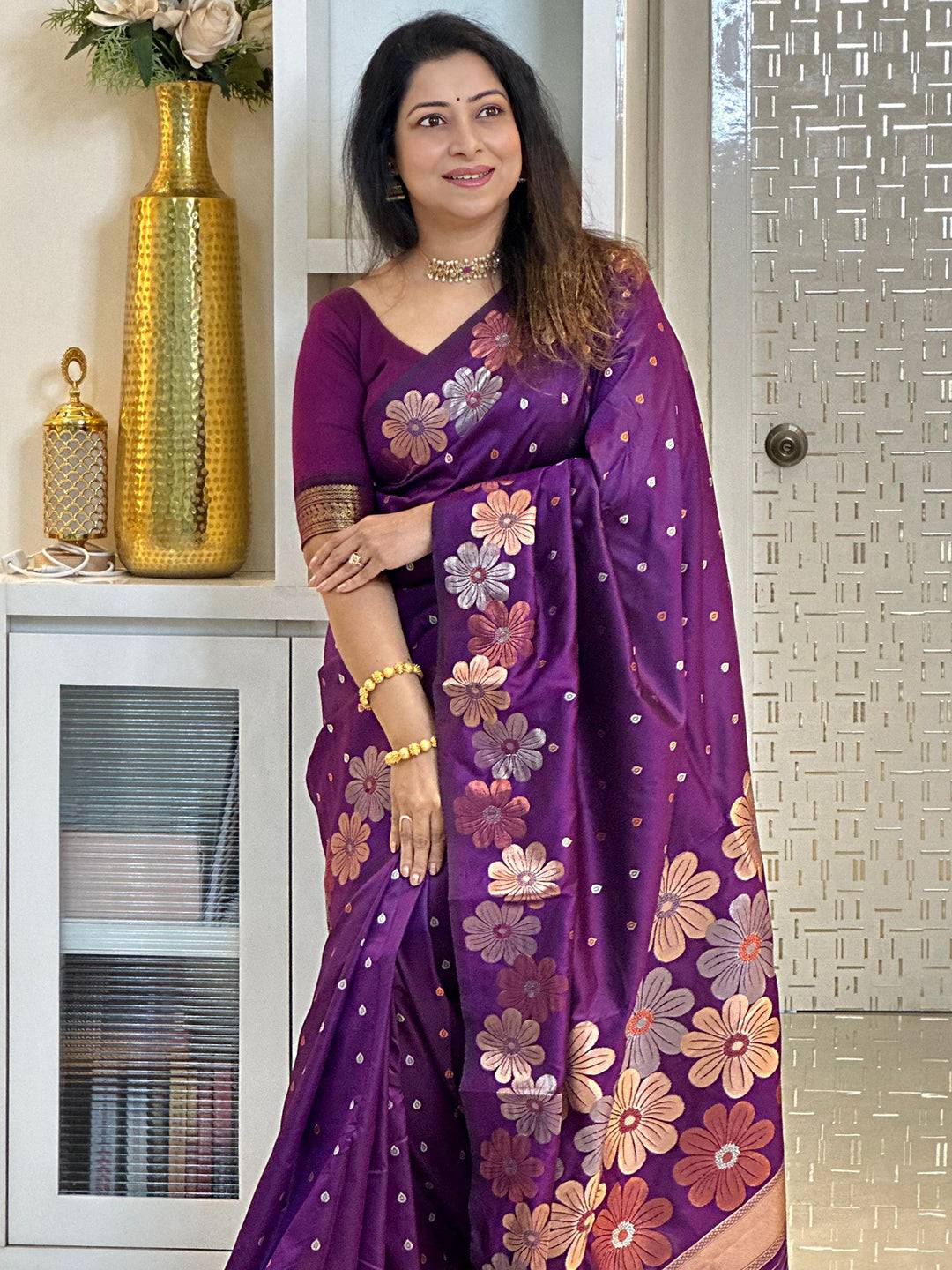 Traditional wine silk saree adorned with zari flowers