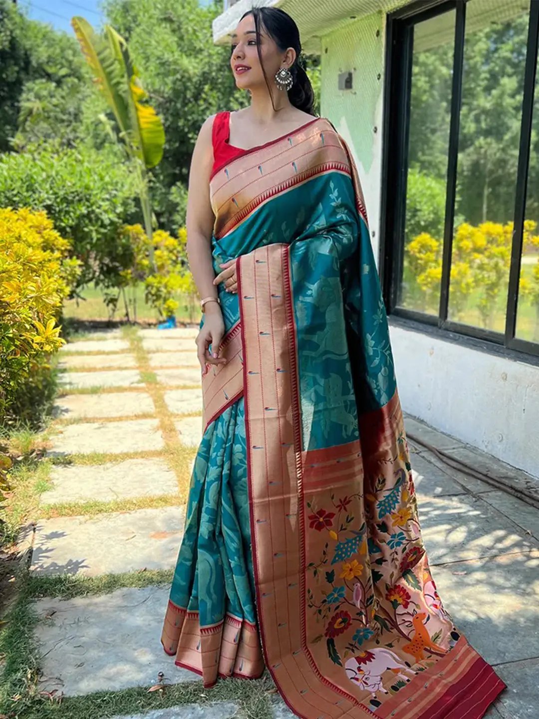 Full view of teal Paithani silk saree with rich pallu and floral motifs