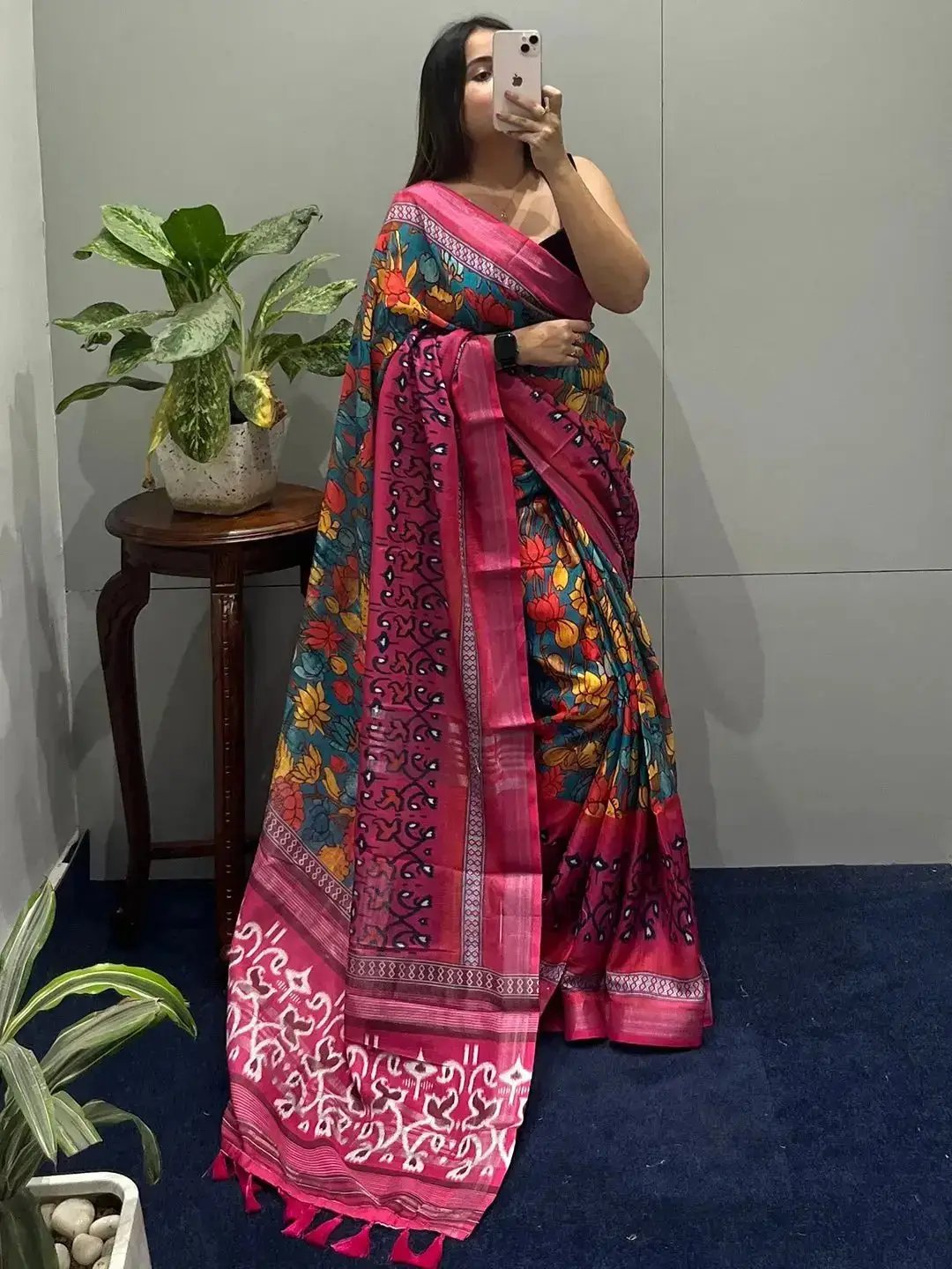 Floral Ikkat printed saree displayed indoors with plants