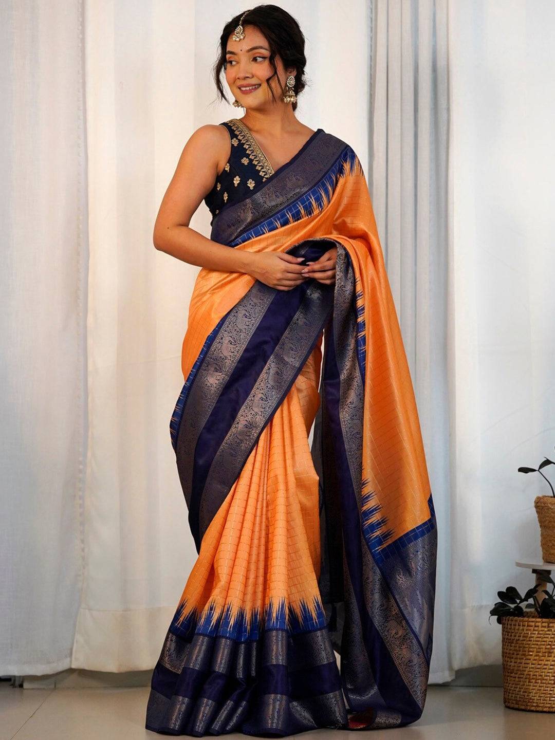 Orange Banarasi silk saree with blue border, party wear.