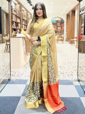 Model showcasing Gold Kalamkari Linen Tissue Saree with red border.