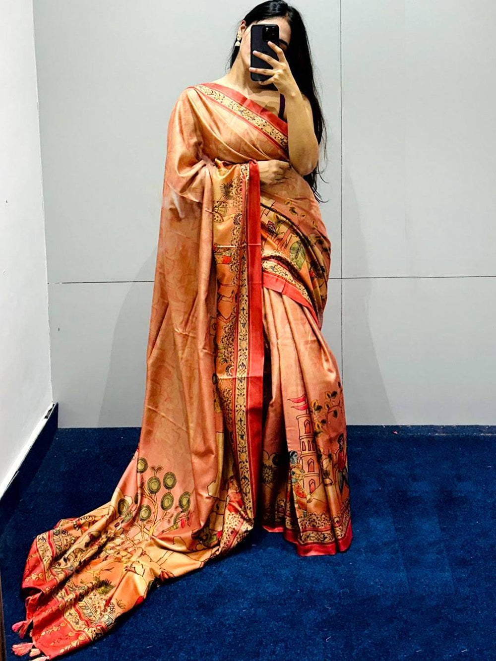 Muvel Kalamkari Print Saree displayed on blue carpet