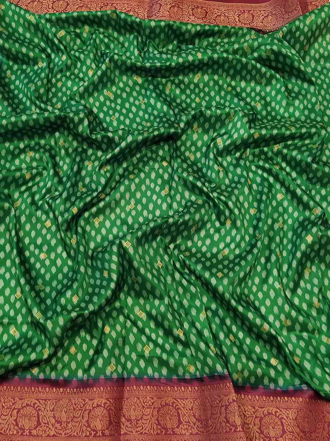 Vibrant green Banarasi soft silk saree with rich Patola pallu.