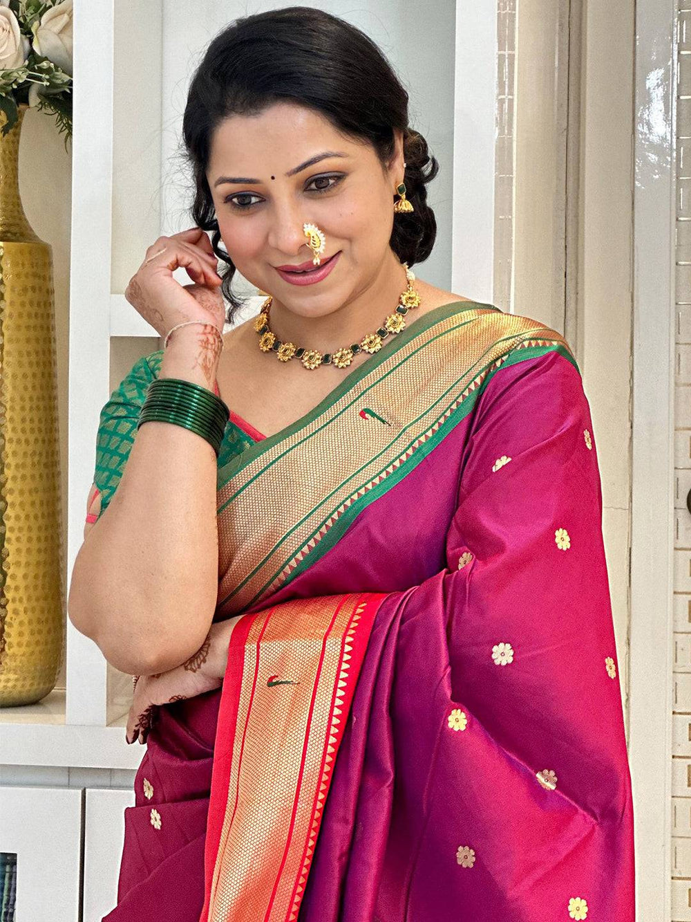 Woman in silk Paithani saree with Ganga Jamuna border, smiling