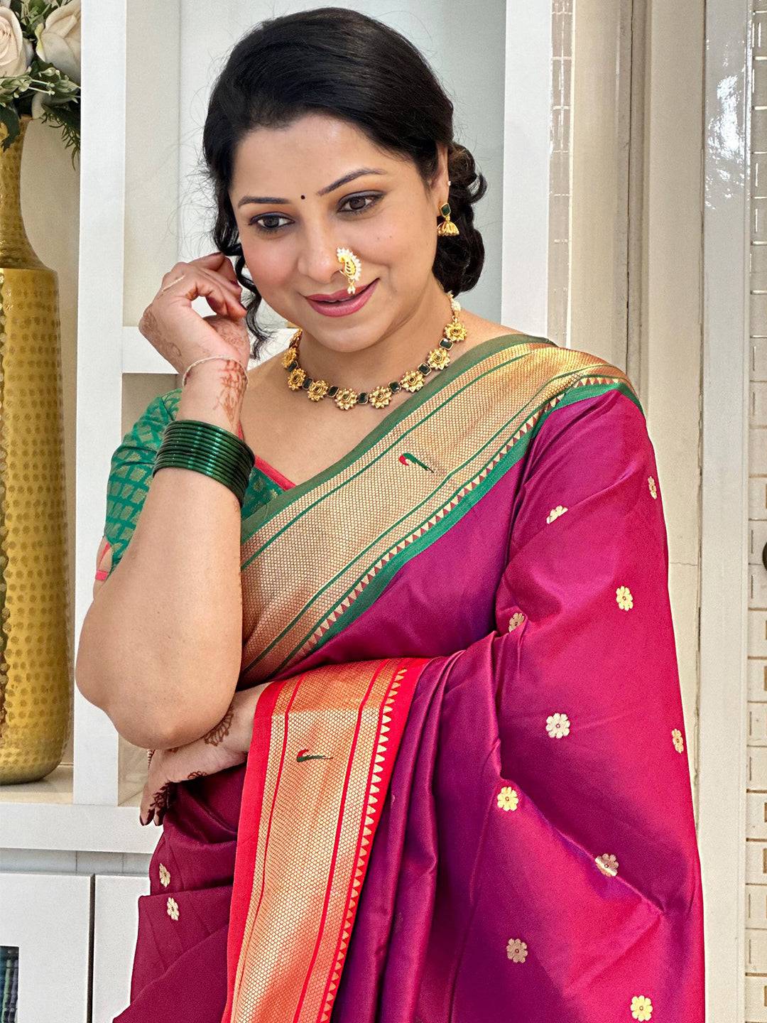 Woman in silk Paithani saree with Ganga Jamuna border, smiling