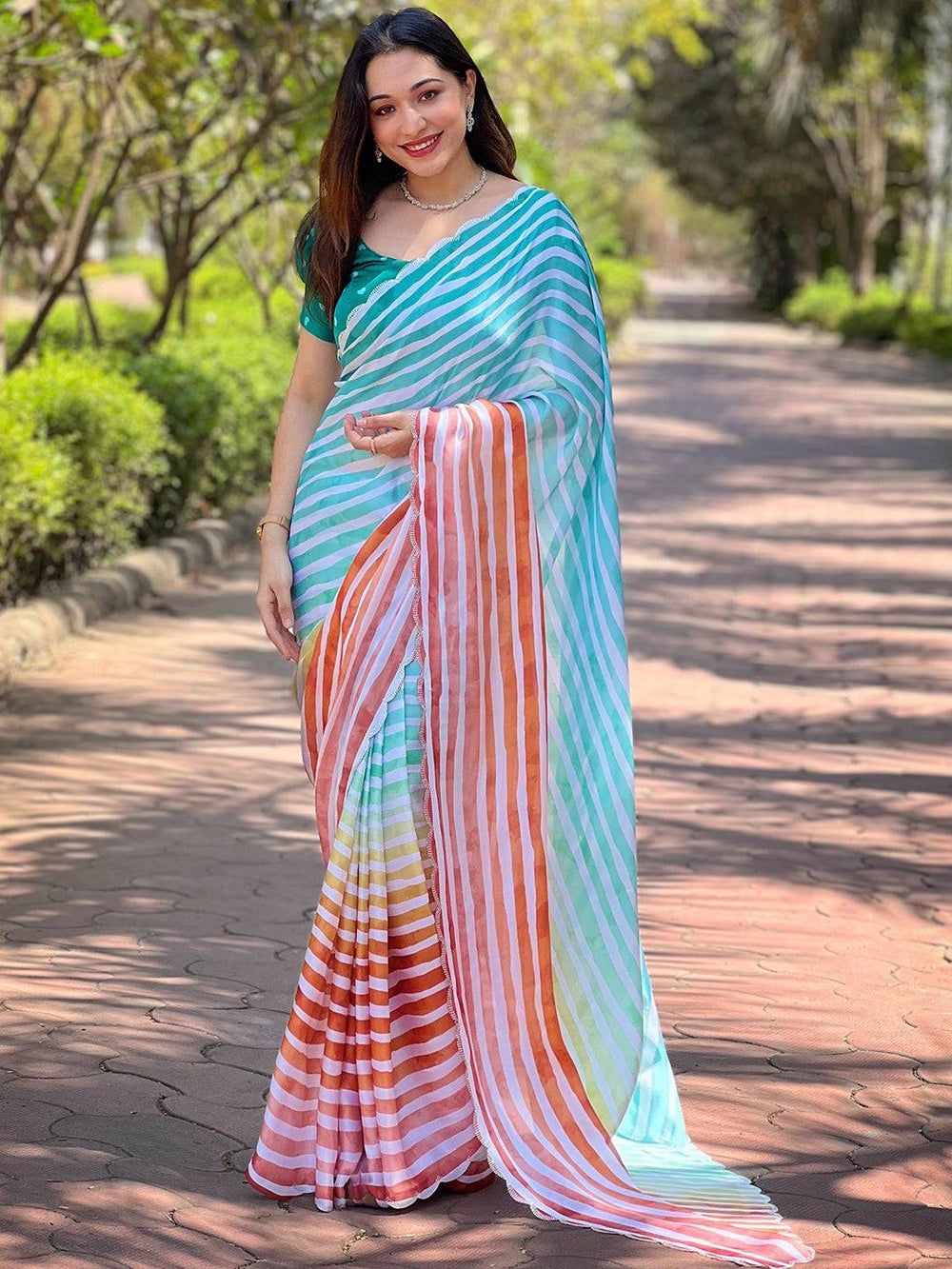 Model wearing colorful striped Leheriya saree