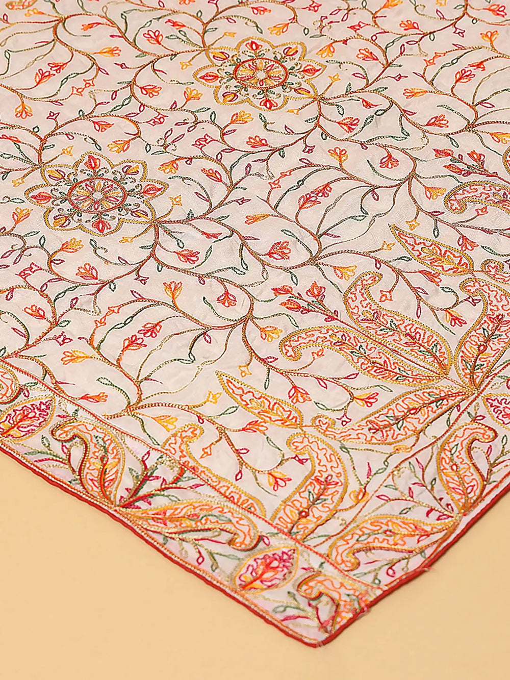 Close-up of Bollywood white dupatta with colorful thread embroidery.