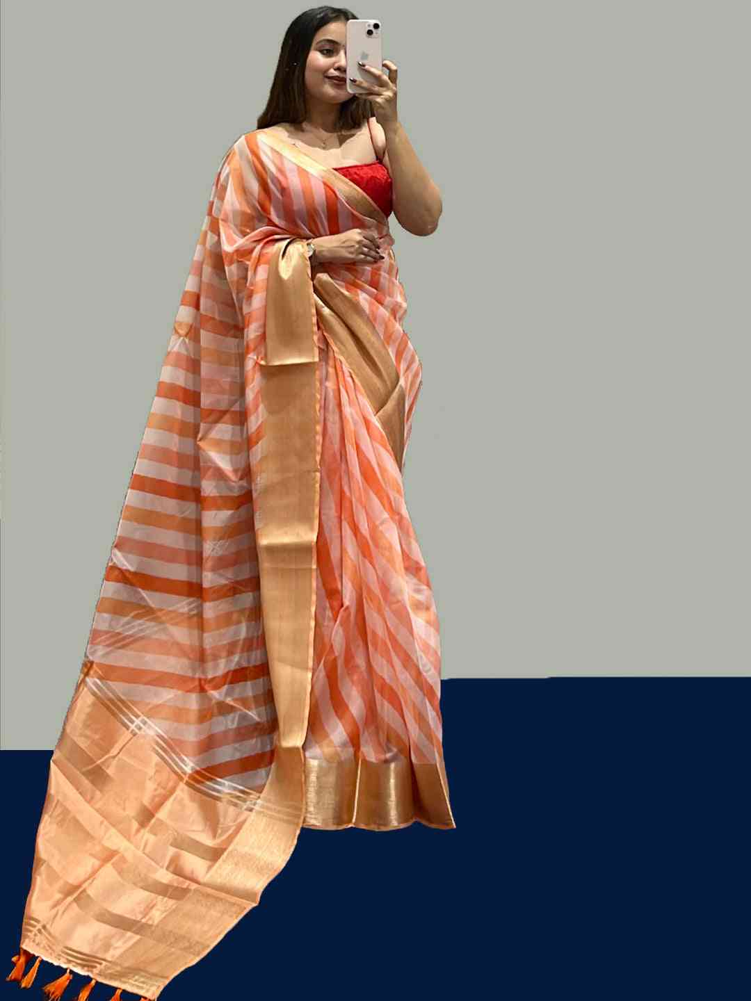Elegant organza leheriya saree in orange stripes with golden border.