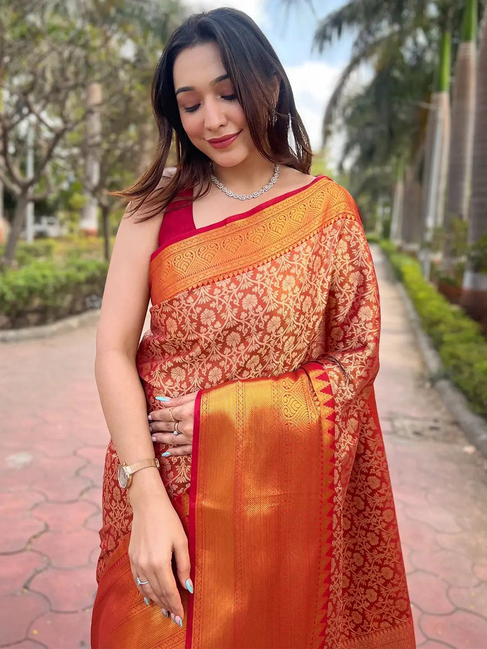 Elegant orange gold tissue saree with detailed jacquard work.