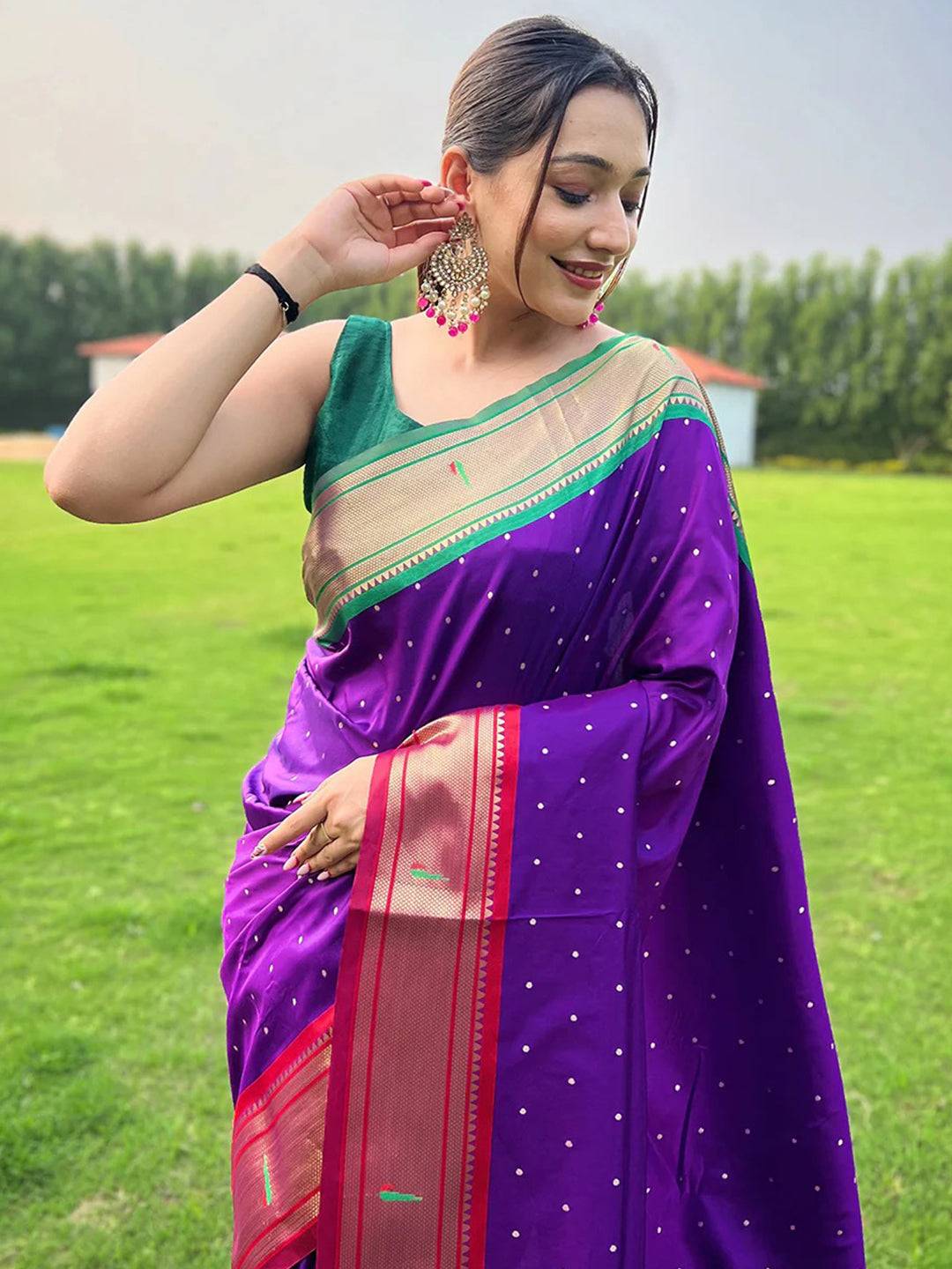 Woman wearing purple Paithani saree with Ganga Jamuna border