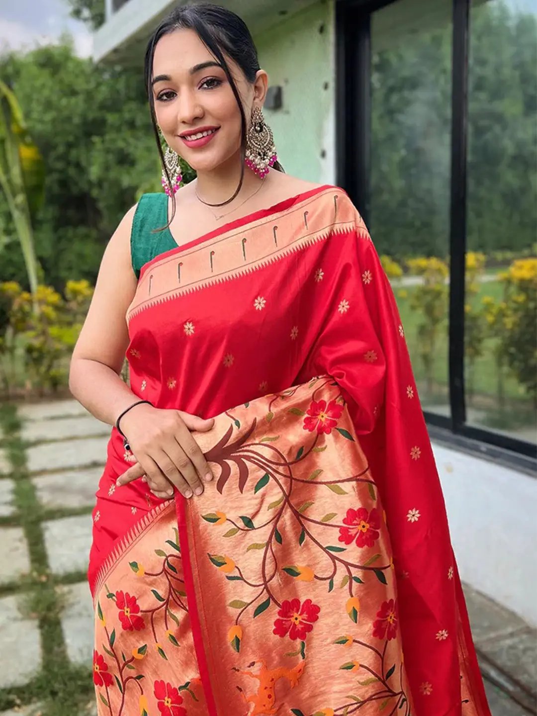 Close-up of red Paithani saree with intricate woven floral pattern
