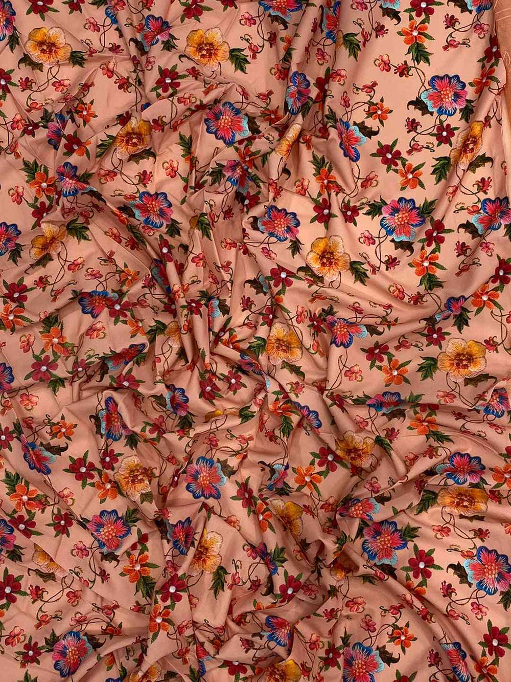 Close-up of floral embroidered chiffon satin fabric.