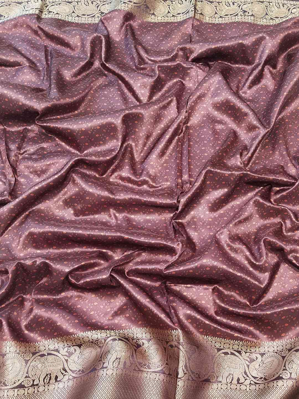 Rich maroon silk fabric with intricate border design