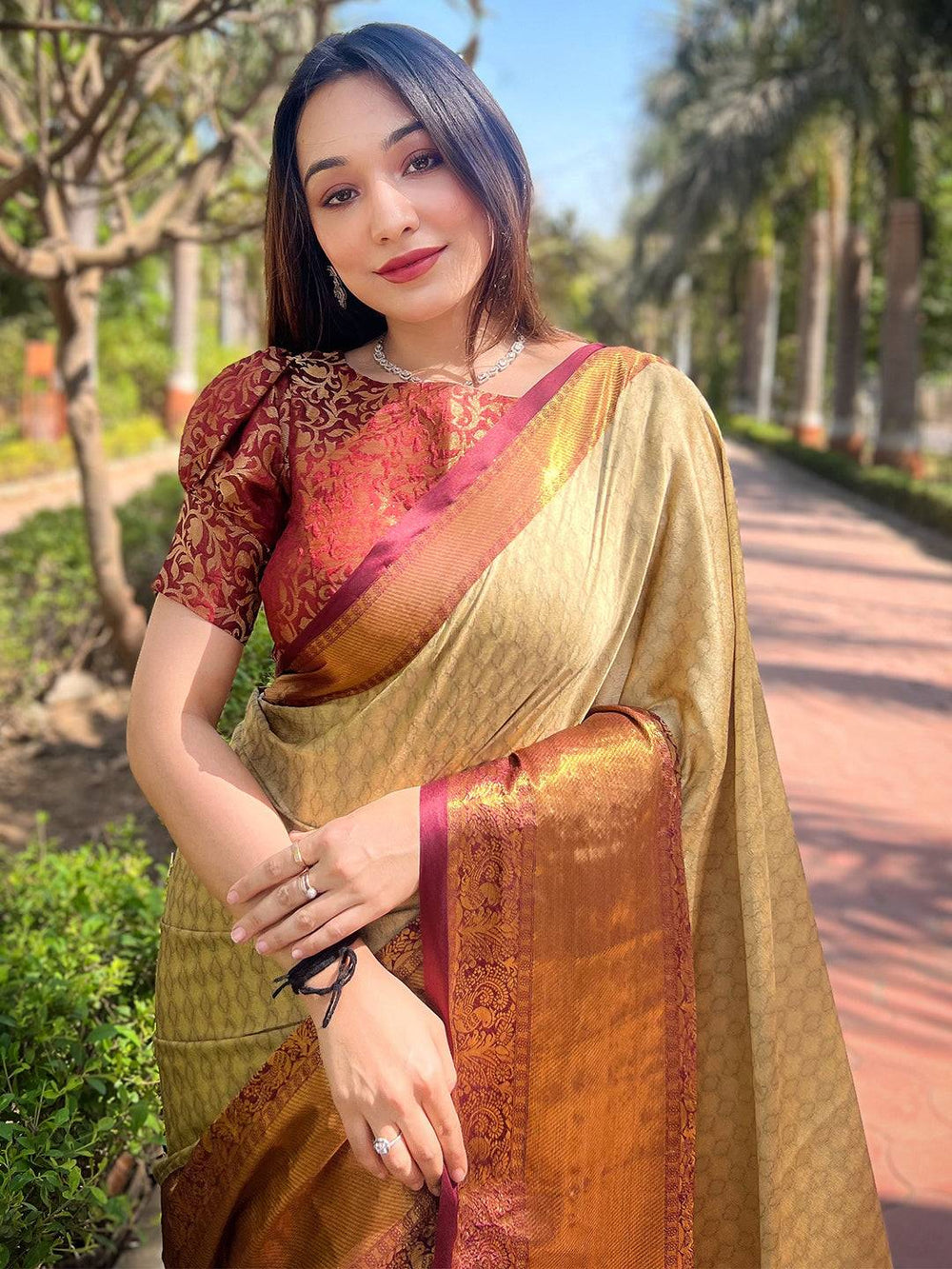 Gold Kanjivaram silk saree with brocade blouse outdoors