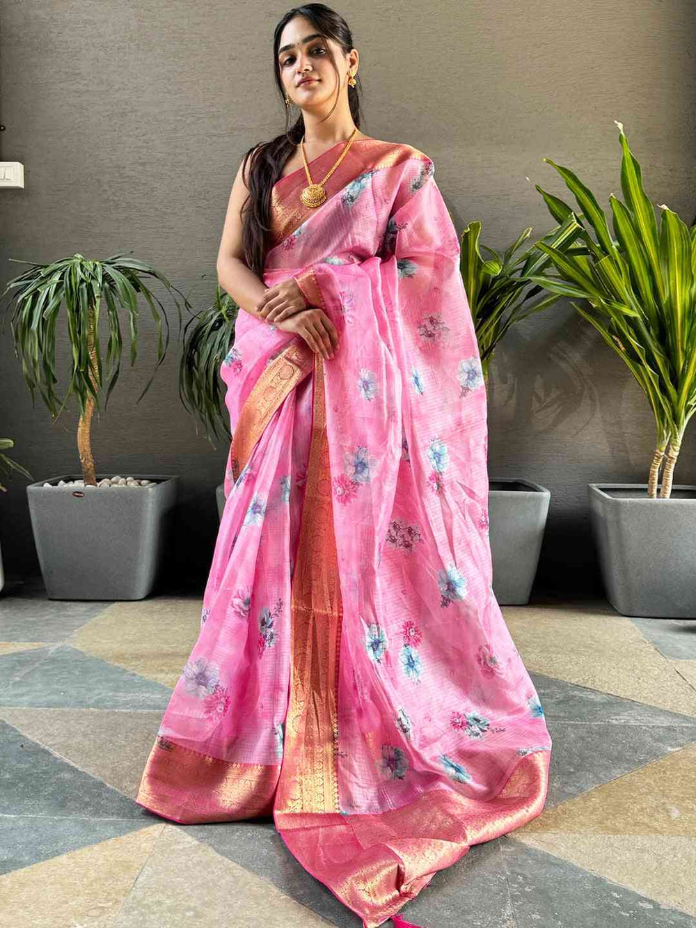 Model showcasing pink Kota silk saree with floral design