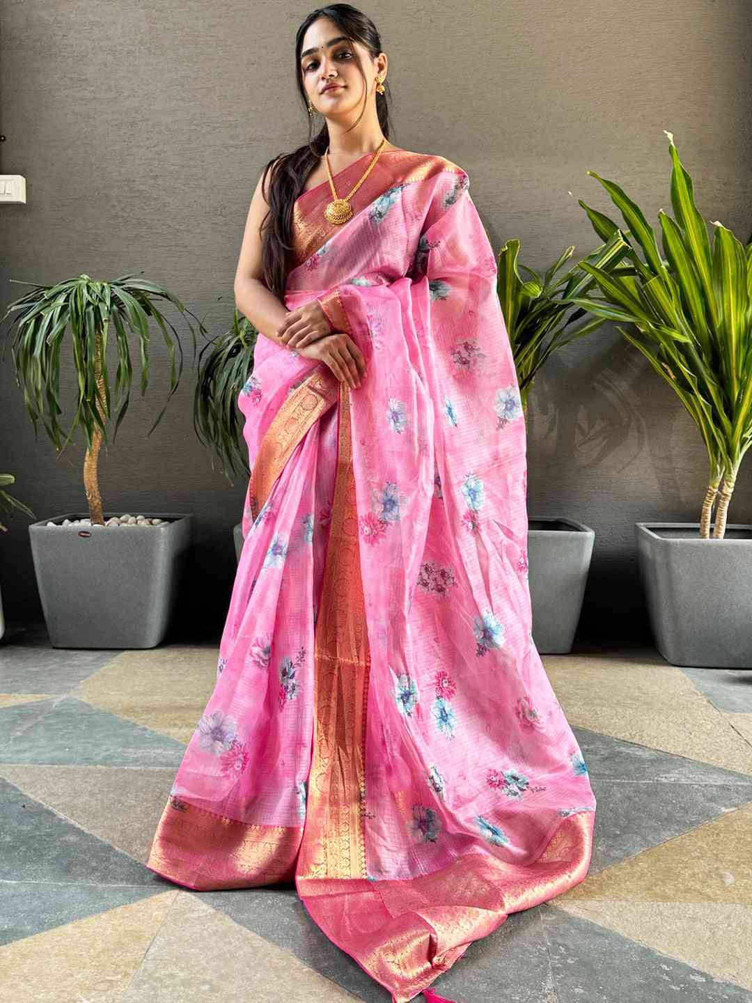 Model showcasing pink Kota silk saree with floral design