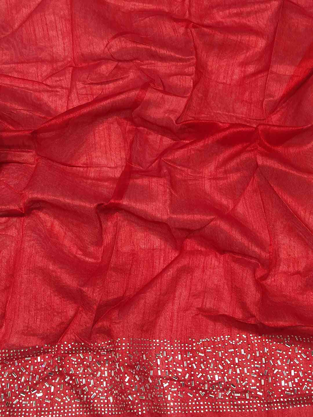 Close-up of red fabric with silver embroidered border