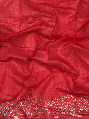 Close-up of red fabric with silver embroidered border