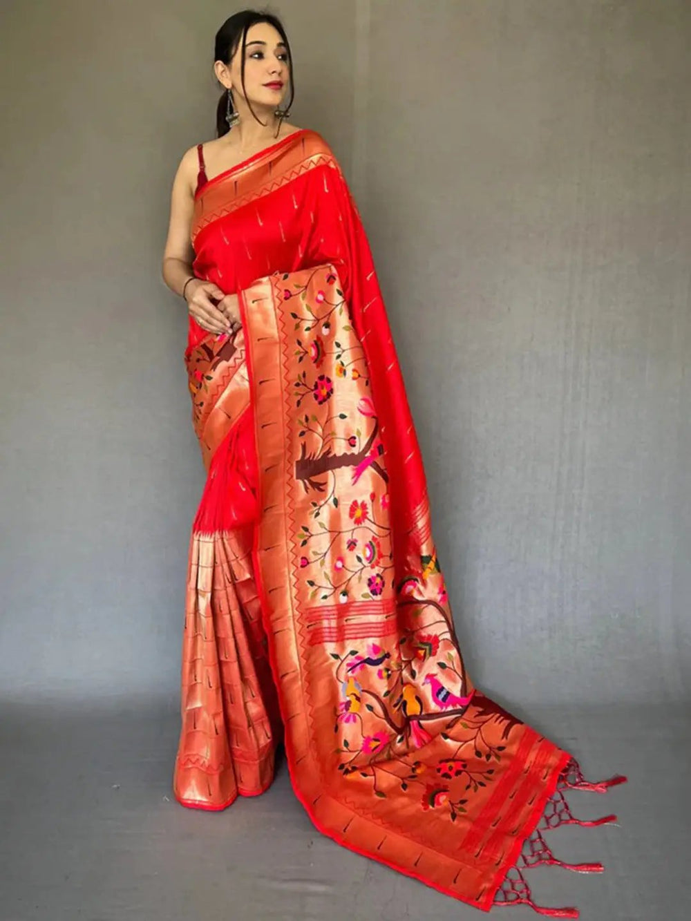 Royal Red Paithani saree with big zari border, model posing.