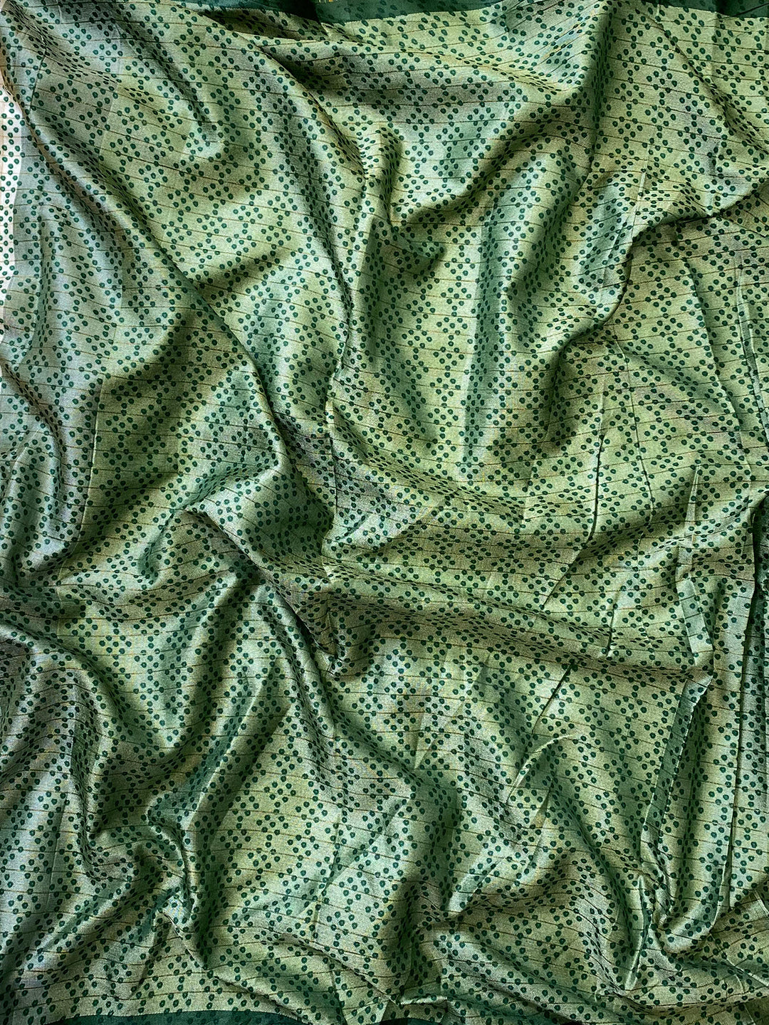 Close-up of green Bandhej print silk fabric