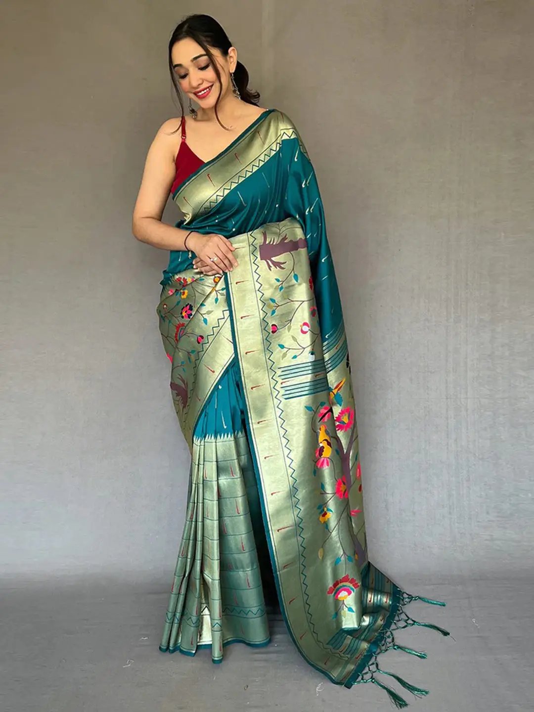 Teal Paithani saree with big zari border, worn by model.