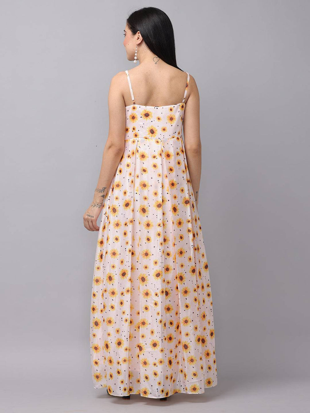 Back view of white sunflower printed dress with spaghetti straps.