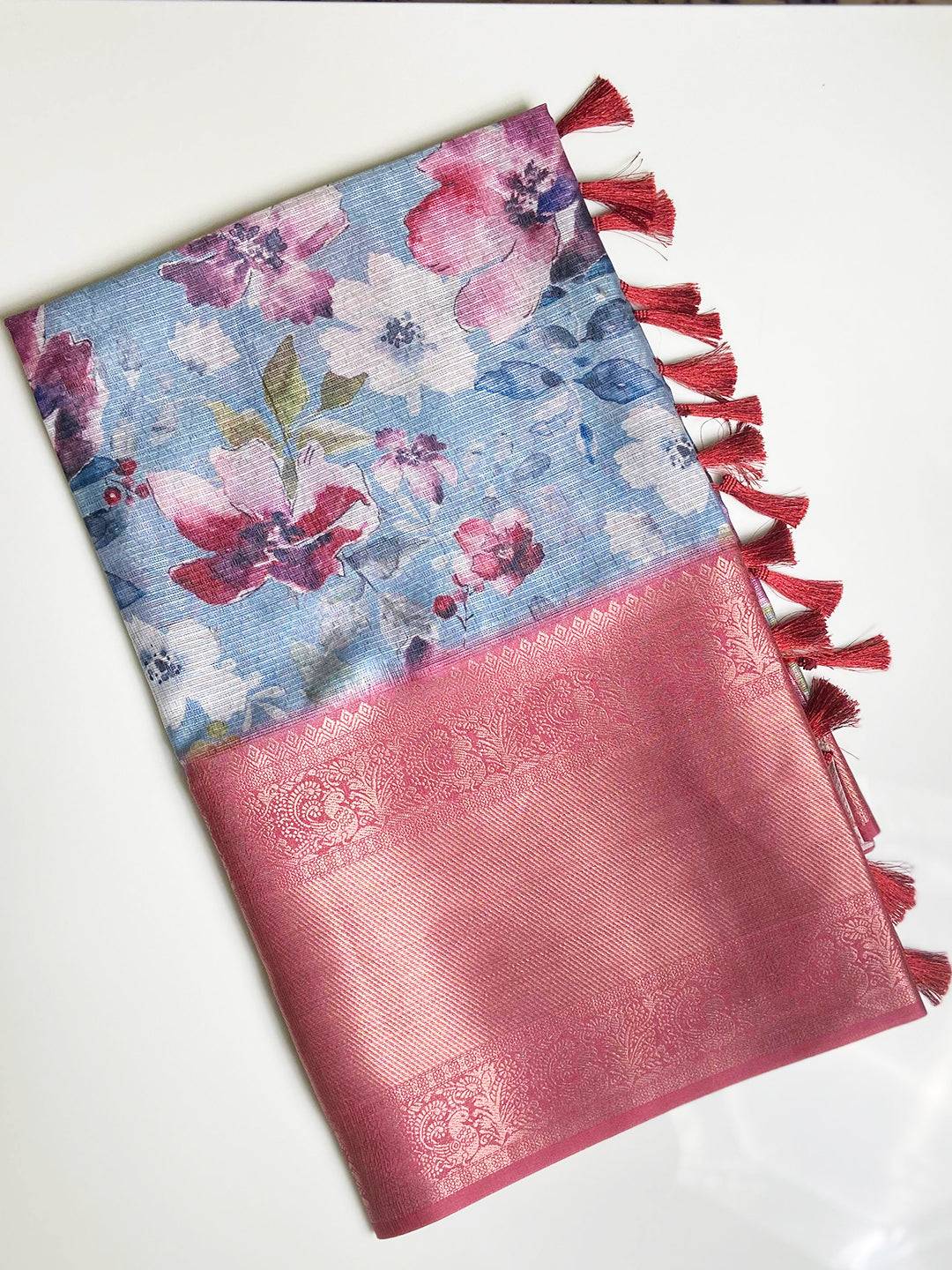 Folded sky blue saree with floral design and pink gold border