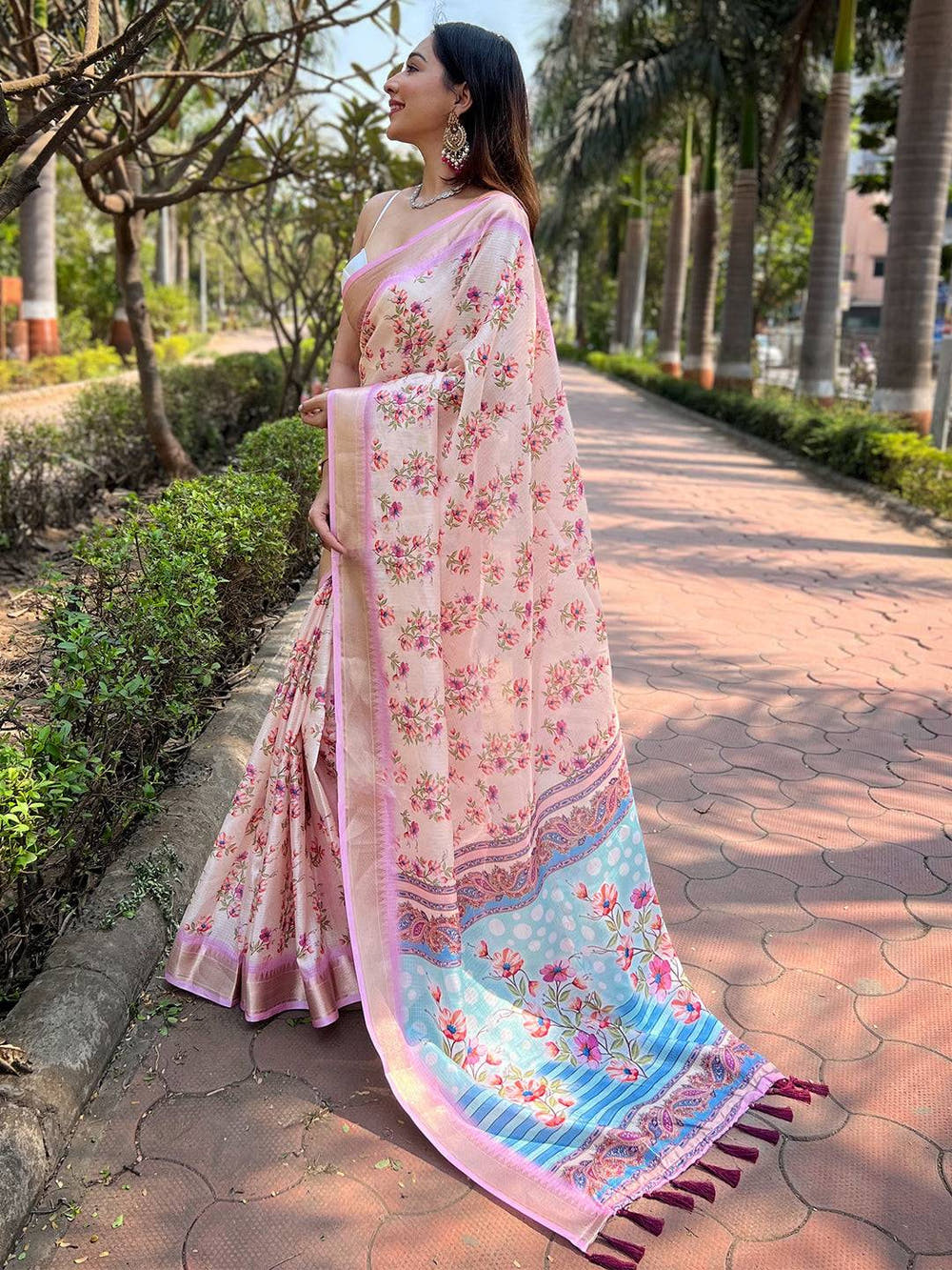 Side view of model in peach Kota saree with floral design