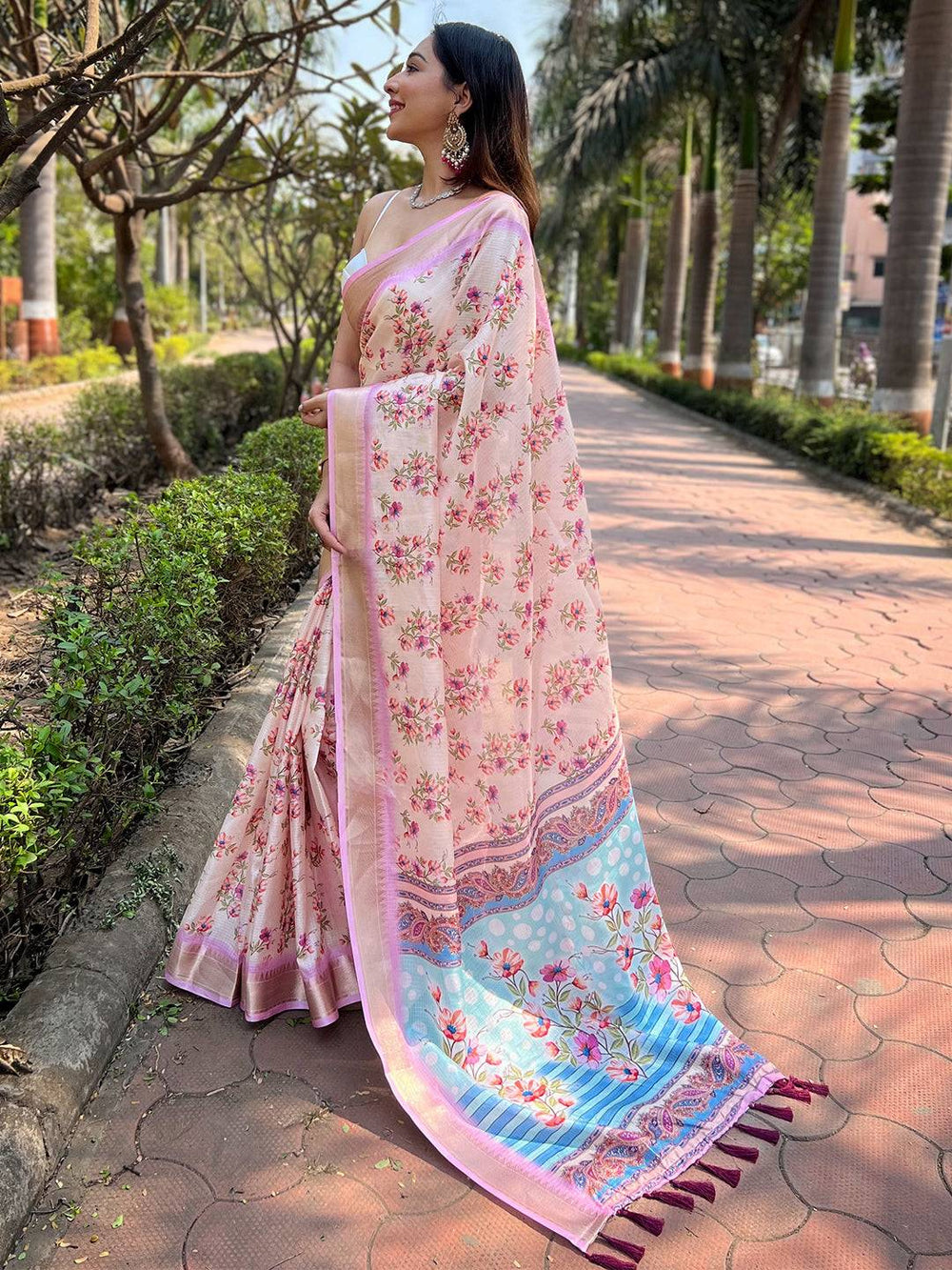 Side view of model in peach Kota saree with floral design