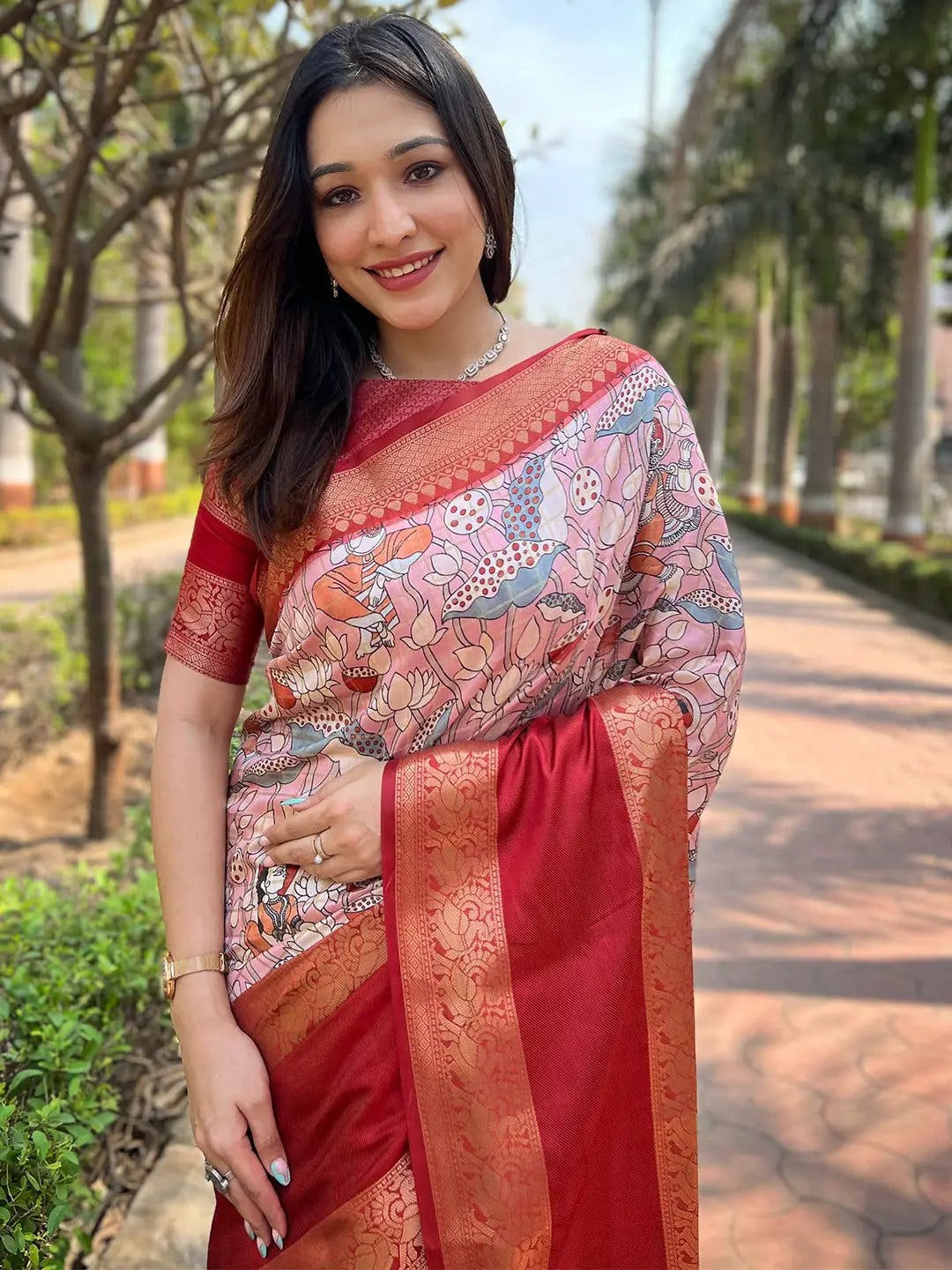 Model wearing pink Banarasi silk saree with detailed border