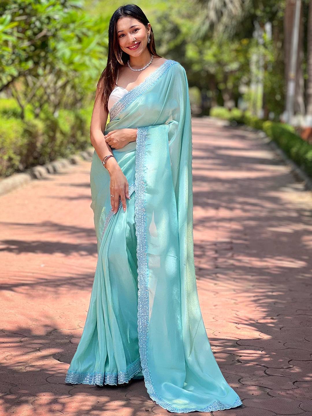 Front view of turquoise pure viscose dyed saree with sequence border