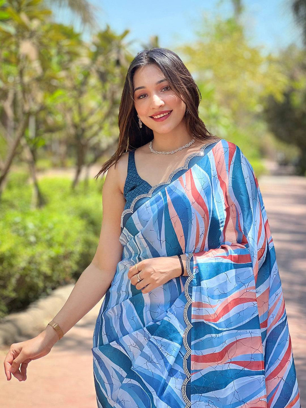 Woman wearing blue batik and polka dots print saree outdoors