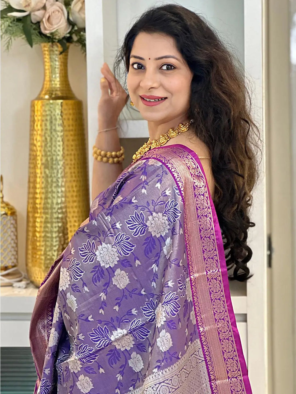 Close-up of woman in purple tissue silk saree