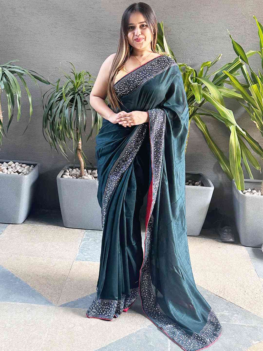 Dark green Vichitra silk saree with Swarovski stones, standing view