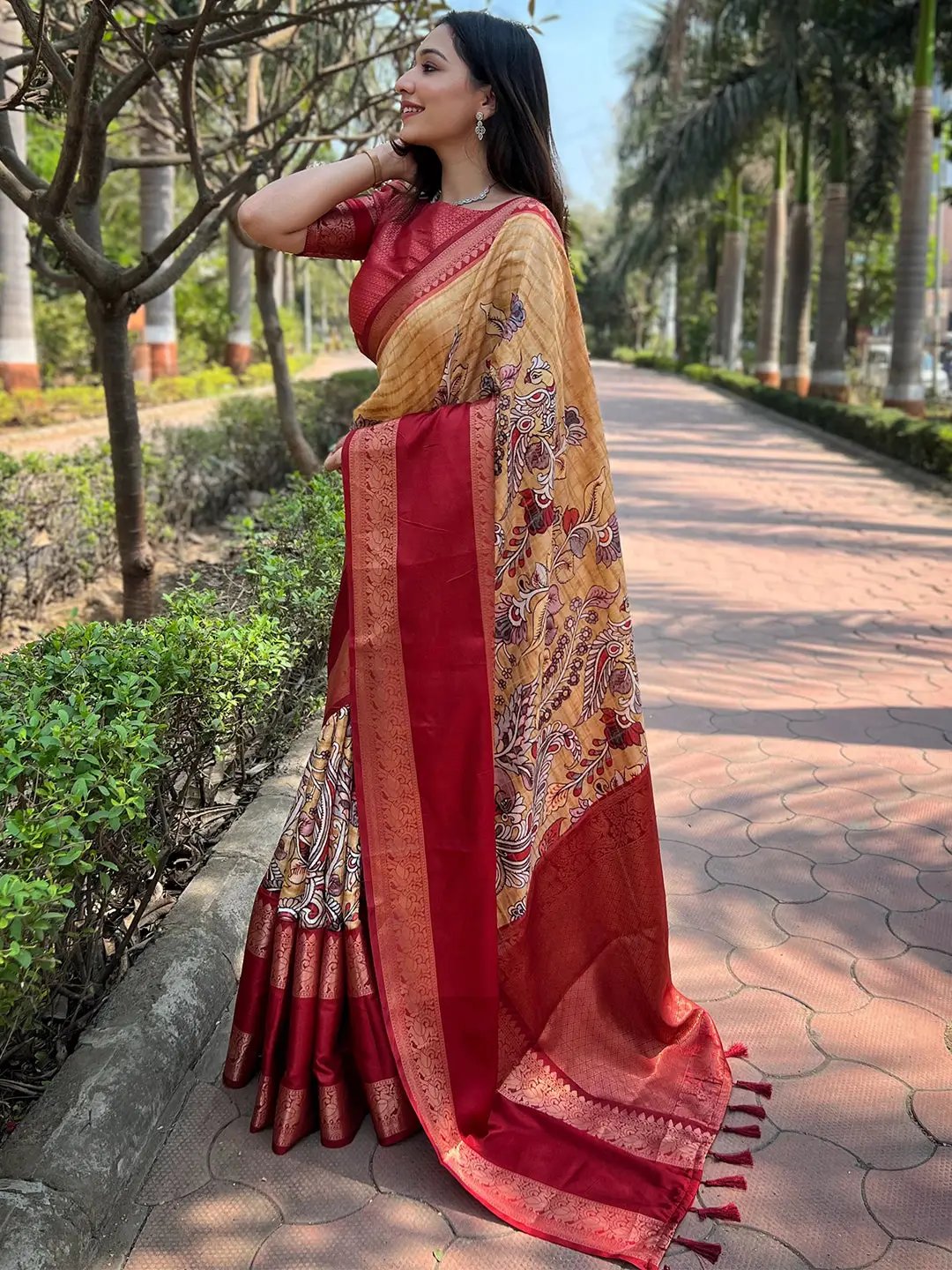 Stylish mustard Banarasi saree with red border and floral patterns.