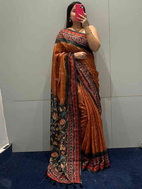 Mirror selfie of orange saree with Bandhej and Kalamkari print