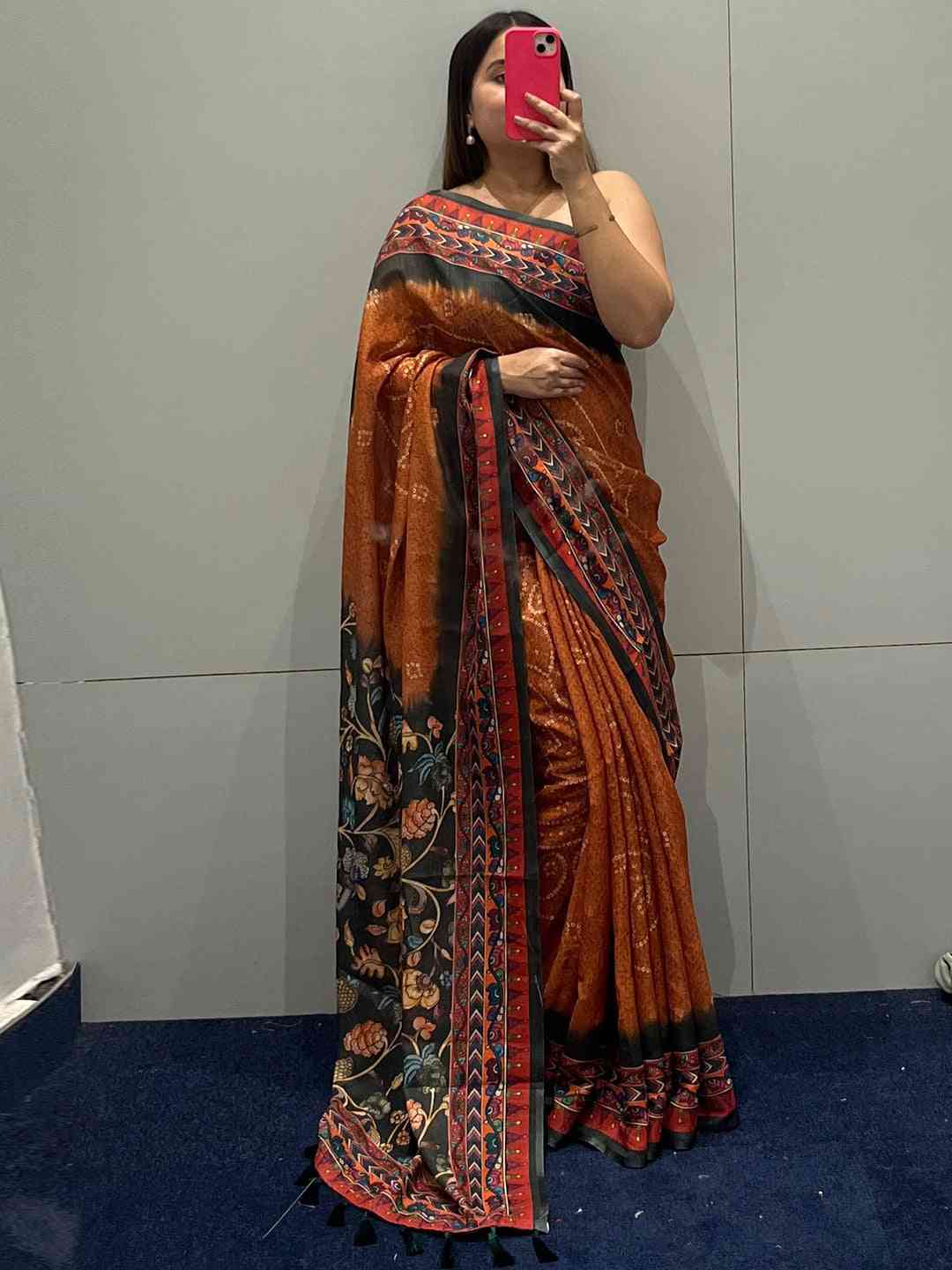 Mirror selfie of orange saree with Bandhej and Kalamkari print